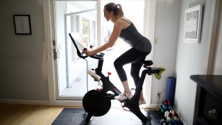 Jen Van Santvoord rides her Peloton exercise bike at her home in San Anselmo, California.
