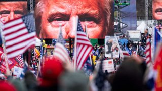 An image of President Donald Trump appears on video screens before his speech to supporters from the Ellipse at the White House in Washington on Wednesday, Jan. 6, 2021, as the Congress prepares to certify the electoral college votes.