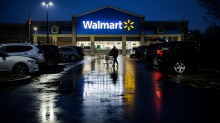 A shopper pushes a cart through the parking lot of a Walmart on the morning of Black Friday in Wilmington, Delaware, on November 25, 2022.