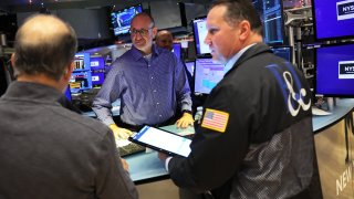 Traders work on the floor of the New York Stock Exchange during morning trading on December 06, 2022 in New York City. The Dow Jones opened low this morning continuing its downward trend dipping more than 400 points as the stock market closed on Monday.