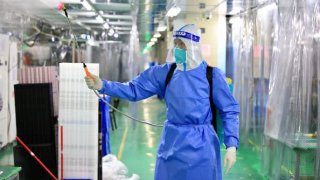 A staff member wearing personal protective equipment disinfects a Foxconn factory at Industrial Park on Nov. 6, 2022 in Zhengzhou, China.