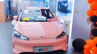 A pink Nezha V and black Nezha U Pro electric car models are on display at a store in Shanghai on Nov. 7, 2021.