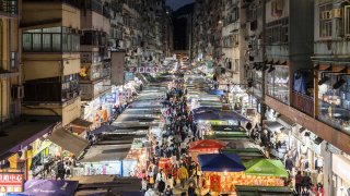 Shoppers walk through a street market in Hong Kong, China, on Sunday, Jan. 30, 2022. Photographer: Chan Long Hei/Bloomberg via Getty Images