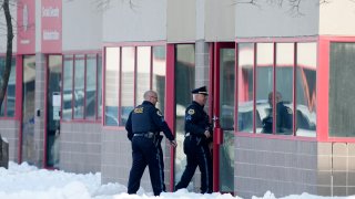 Law enforcement officers enter the Starts Right Here building, Monday, Jan. 23, 2023, in Des Moines, Iowa. Police say two students were killed and a teacher was injured in a shooting at the Des Moines school on the edge of the city's downtown.