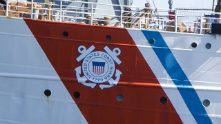The logo of the United States Coast Guard can be seen on the hull of the American sailing training ship "Eagle."