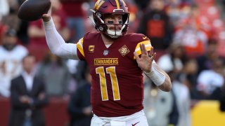 Carson Wentz #11 of the Washington Commanders throws a pass during the second half against the Cleveland Browns at FedExField on January 01, 2023 in Landover, Maryland. (Photo by Todd Olszewski/Getty Images)