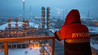 An employee looks out over the petroleum-cracking complex at the Lukoil-Nizhegorodnefteorgsintez oil refinery in Nizhny Novgorod, Russia.