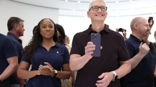 Apple CEO Tim Cook holds a new iPhone 14 Pro during an Apple special event on September 07, 2022 in Cupertino, California.