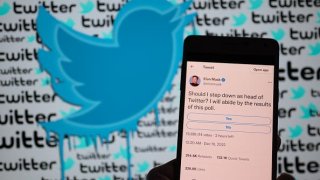 Elon Musk Twitter page seen on mobile with his poll to step down as head of Twitter