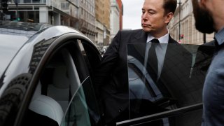 Tesla CEO Elon Musk and his security detail depart the company’s local office in Washington, January 27, 2023.