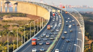 Trucks and passenger cars drive across the Sutong Bridge in the city of Suzhou near Shanghai on Jan. 27, 2023, during the Lunar New Year holiday.