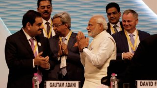 NDIA – JANUARY 18: Prime Minister Narendra Modi with Gautam Adani, chairman and founder of the Adani Group, and other delegates at Vibrant Gujarat Global Summit, at Mahatma Mandir Exhibition cum Convention Centre, on January 18, 2019 in Gandhinagar, India.