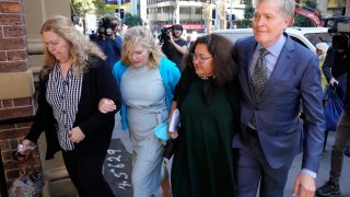 Steve Johnson, right, with his sisters, Terry, left, and Rebecca and his wife Rosemarie, second right, arrive at the Supreme Court in Sydney on May 2, 2022, for a sentencing hearing in the murder of Scott Johnson, Steve, Terry and Rebecca’s brother.