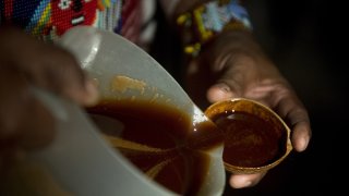 FILE - A healer pours ayahuasca tea before a ceremonial ritual, in La Calera, Cundinamarca department, Colombia.