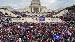 FILE - Trump supporters gather outside the Capitol building in Washington, D.C., Jan. 6, 2021.