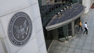 People exit the headquarters of the U.S. Securities and Exchange Commission (SEC) in Washington, D.C., May 12, 2021.