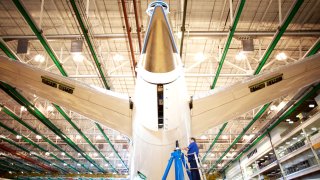 An employee works on the tail of a Boeing Co. Dreamliner 787 plane on the production line at the company’s final assembly facility in North Charleston, South Carolina.