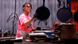 A worker packages cast iron cookware at the Lodge Manufacturing Co. factory in South Pittsburg, Tennessee, on Monday, March 7, 2022.