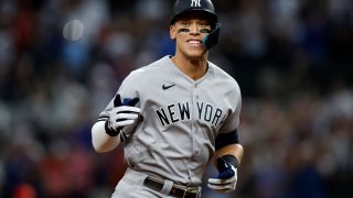 New York Yankees right fielder Aaron Judge (99) rounds the bases after hitting home run number sixty-two to break the American League home run record in the first inning against the Texas Rangers at Globe Life Field.