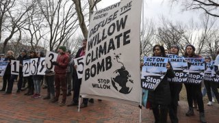 Climate activists gather to protest with demanding President Biden stop the Willow Project by unfurling a banner on the Lafayette Square in front of the White House on January 10, 2023 in Washington D.C.