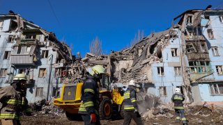 Ukrainian rescuers work on the five-storey residential building destroyed after a missile strike in Zaporizhzhia on March 2, 2023, amid the Russian invasion of Ukraine.