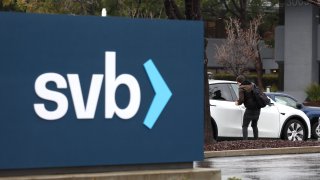 An employee gets into his car after arriving to work to a shuttered Silicon Valley Bank (SVB) headquarters on March 10, 2023 in Santa Clara, California.