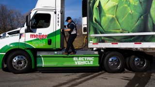 A driver operates a Daimler Freightliner eCascadia all-electric semitruck during a Meijer delivery in Bath, Michigan, US, on Tuesday, Feb. 14, 2023.