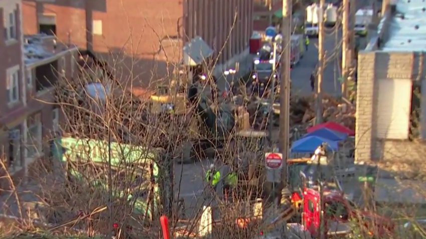 Rescue crews work on the site of an explosion at the R. M. Palmer chocolate factory in West Reading on March 26.