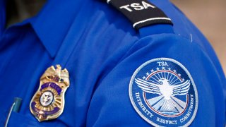 FILE - A Transportation Security Administration officer works at Dallas Love Field Airport on June 24, 2020, in Dallas.