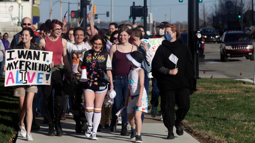 More than 100 people, many of them transgender youth, march around the Kansas Statehouse on the annual Transgender Day of Visibility, Friday, March 31, 2023, in Topeka, Kan.