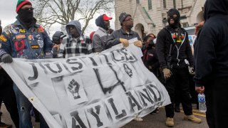 Protesters gather in front of the First Congregational Church before marching to the Federal Courthouse in Akron, Ohio, Tuesday, April 18, 2023.