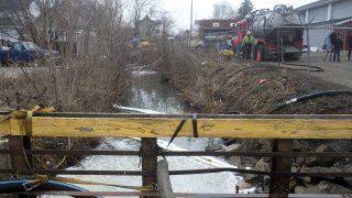 Crews run operations to clean and test the Sulphur Run creek in East Palestine, Ohio, US