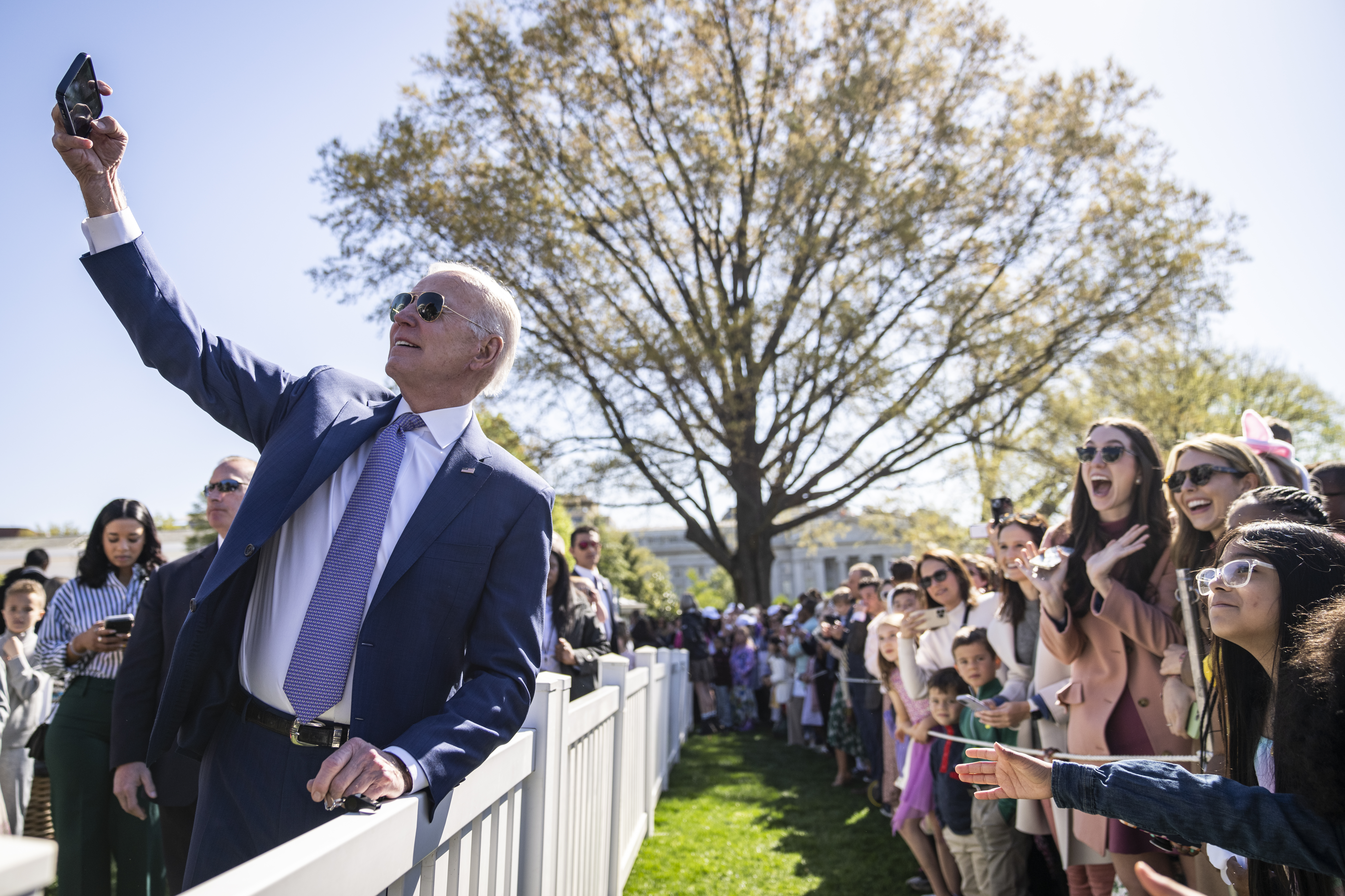 President Joe Biden takes photos with guests at the annual Easter Egg Roll on the South Lawn of the White House on April 10, 2023 in Washington, D.C.