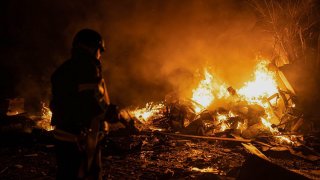 In this photo provided by the Ukrainian Emergency Situations Ministry, firefighters put out fire caused by fragments of a Russian rocket after it was shot down by air defense system during the night Russian rocket attack in Kyiv, Ukraine, early Tuesday, May 16, 2023.