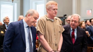 FILE – Alex Murdaugh speaks with his legal team before he is sentenced to two consecutive life sentences for the murder of his wife and son by Judge Clifton Newman at the Colleton County Courthouse on Friday, March 3, 2023 in in Walterboro, S.C. Convicted murderer Murdaugh is facing federal charges for the first time after being indicted on 22 financial fraud charges related to schemes the former attorney used to steal settlement money from clients.