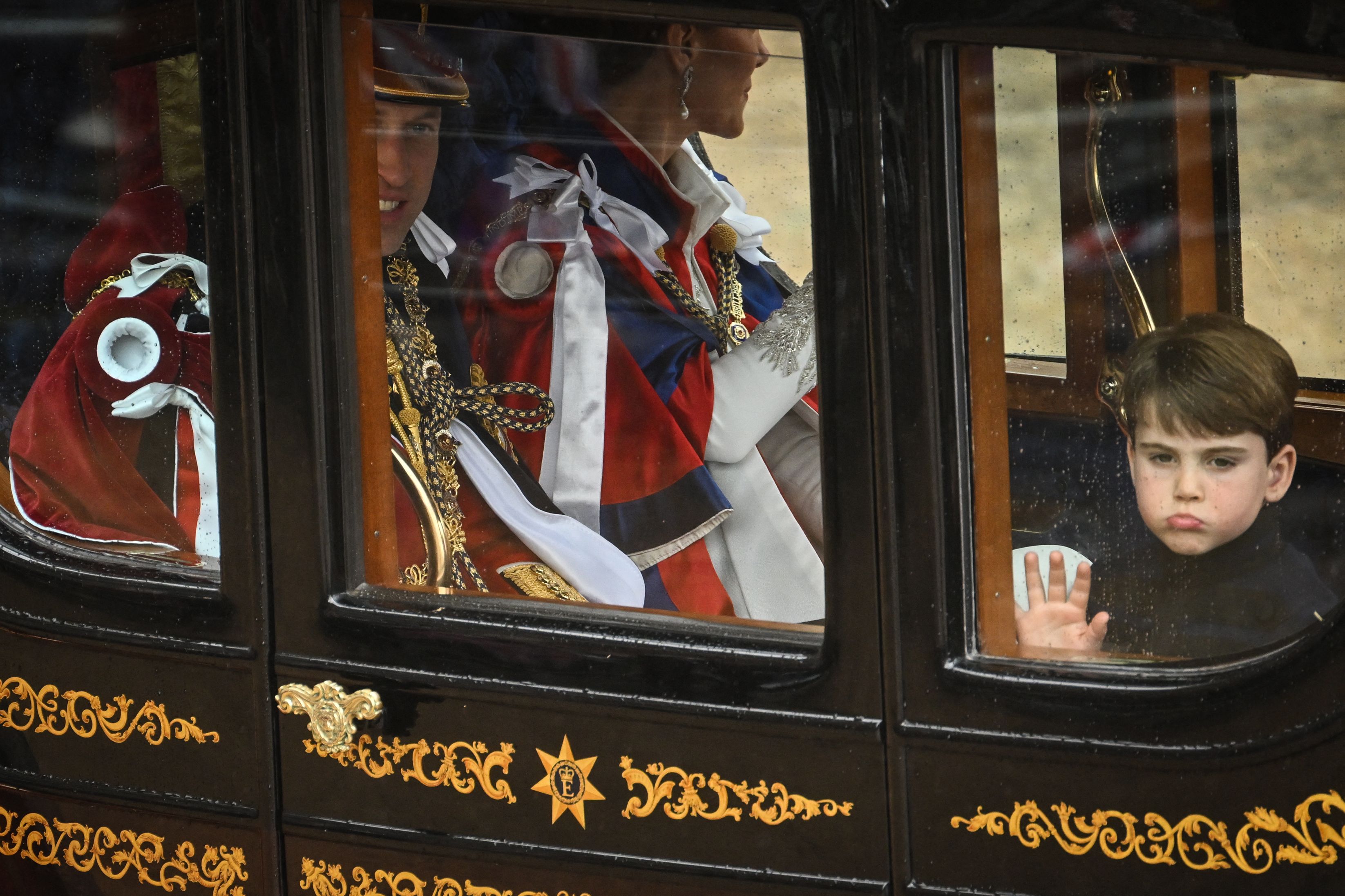 Britain’s Prince Louis of Wales travel back to Buckingham Palace with his parents from Westminster Abbey in central London on May 6, 2023, after the coronations of King Charles III and Queen Camilla.