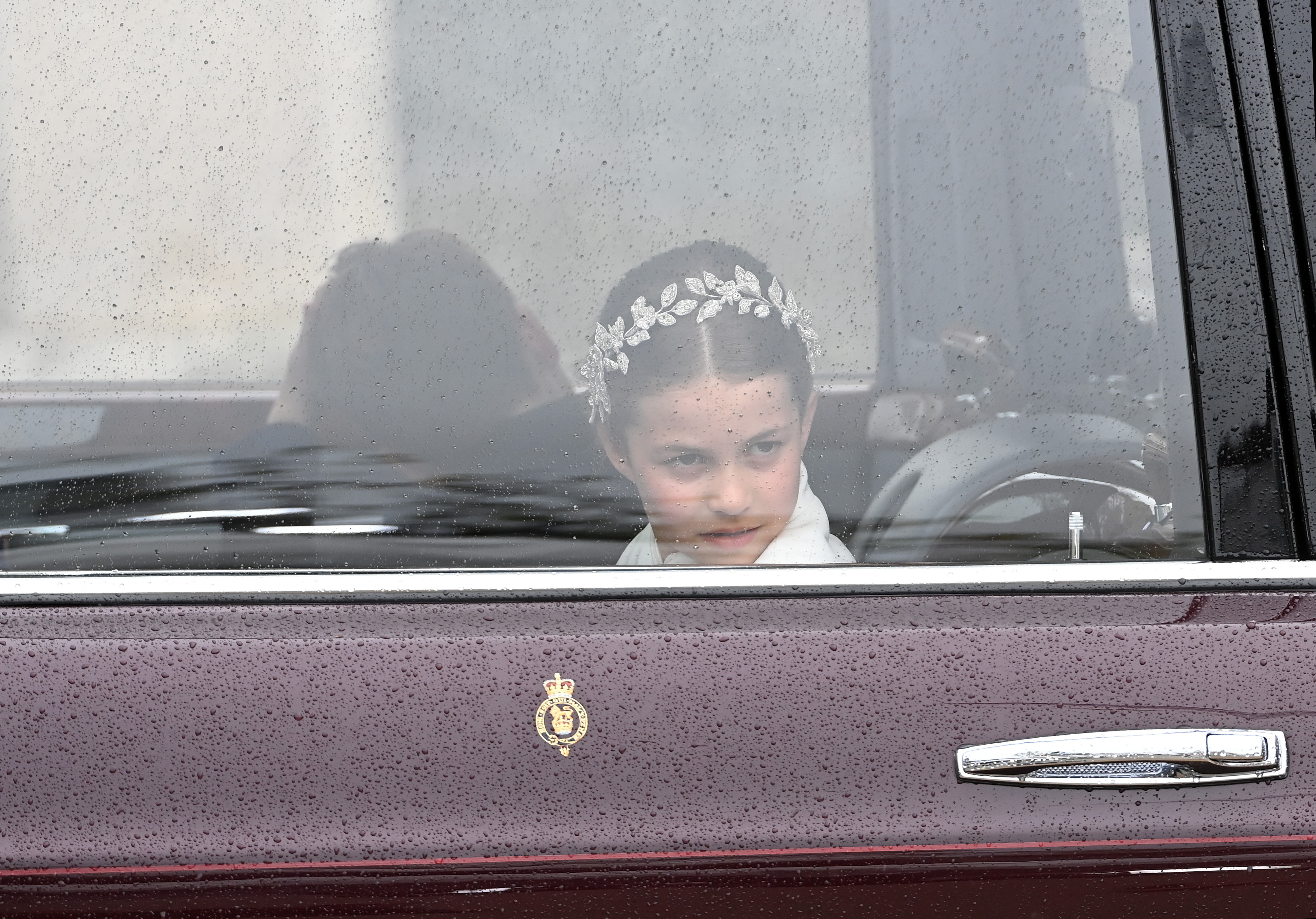 Princess Charlotte of Wales travel in the state car during the Coronation of King Charles III and Queen Camilla on May 6, 2023 in London, England.