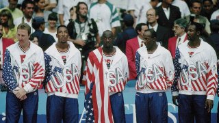 (L-R) USA Larry Bird, Scottie Pippen, Michael Jordan, Clyde Drexler, and Karl Malone victorious with USA flag after winning final game, Barcelona, ESP 8/8/1992.