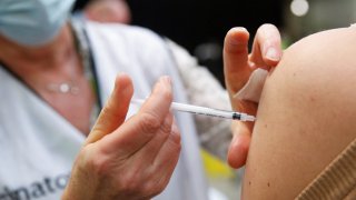 A woman receives a booster dose of the Moderna coronavirus disease (COVID-19) vaccine at a vaccination centre in Antwerp, Belgium, February 1, 2022.