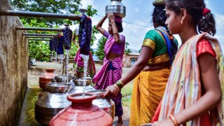 Women fill water from a municipal tank on May 26, 2023 in the Peth Taluka village in India.