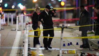 Denver Police Department investigators work the scene of a mass shooting along Market Street between 20th and 21st avenues during a celebration after the Denver Nuggets won the team’s first NBA Championship early Tuesday, June 13, 2023, in Denver.