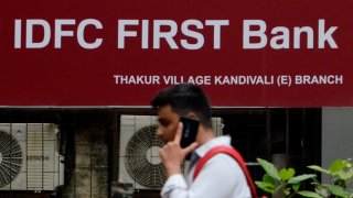 IDFC First bank signage is seen outside a branch in Mumbai, India, 04 July, 2023. IDFC First Bank merges with IDFC Limited. 155 shares of IDFC First Bank will be alloted for 100 shares of IDFC according to an Indian media report.