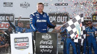 Chris Buescher, driver of the No. 17 Fastenal Ford, celebrates with the checkered in victory lane after winning the NASCAR Cup Series Cook Out 400 at Richmond Raceway on July 30, 2023 in Richmond, Va.