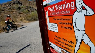 A cyclist finishes his ride early to beat high temperatures, Monday, July 10, 2023, in Phoenix.