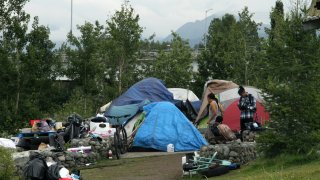 An outdoor tent city for the homeless is shown July 26, 2023, across from the city’s historic railroad depot in downtown Anchorage, Alaska.