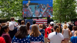 United States’ forward Megan Rapinoe is seen on a screen posing with the Golden Ball as fans watch the France 2019 Women’s World Cup final football match between USA and the Netherlands, in Washington, DC, on July 7, 2019. (Photo by Alastair Pike / AFP)        (Photo credit should read ALASTAIR PIKE/AFP via Getty Images)