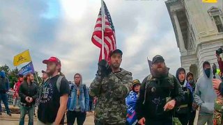 In this image from video provided by the Justice Department in the government's sentencing memo, Christopher Michael Alberts, right, yells at U.S. Capitol Police officers during the Jan. 6, 2021, riot at the U.S. Capitol.