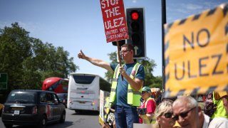 Demonstrators hold placards and chant slogans during a rally to protest against the expansion of the Ultra Low Emission Zone (ULEZ) in London, at Marble Arch, central London, on June 25, 2023.