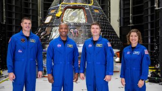 Artemis II crew members, from left, Jeremy Hansen, Victor Glover, Reid Wiseman and Christina Koch, stand together at NASA’s Kennedy Space Center in Florida, in front of an Orion crew module on Tuesday, Aug. 8, 2023.