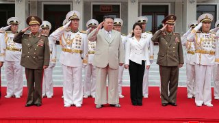 This photo provided on Tuesday, Aug. 29, 2023, by the North Korean government, North Korean leader Kim Jong Un, center,  with his daughter, center right, reportedly named Ju Ae, review the honor guard during their visit to the navy headquarter in North Korea, on Aug. 27, 2023.  Independent journalists were not given access to cover the event depicted in this image distributed by the North Korean government. The content of this image is as provided and cannot be independently verified. Korean language watermark on image as provided by source reads: “KCNA” which is the abbreviation for Korean Central News Agency.